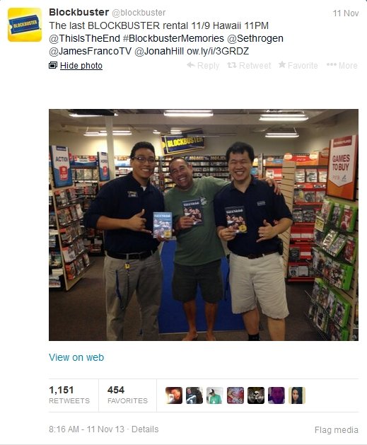 Two Blockbuster employees pose with the chain's last customer.