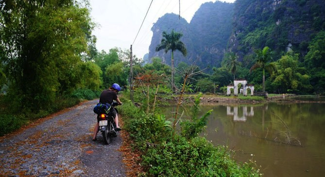 Small road in between majestic mountains on the way to Cuc Phuong National Park.

