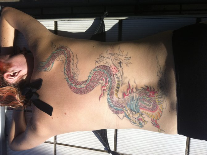 I was always a small girl. I was teased and bullied often.  I knew that deep within me was the spirit of a dragon that no one could mess with.  It was my lifelong dream to have a neck to butt dragon on my back.  I was blessed that it was finally completed in Asia (Taiwan) by master JERRY LIU....and yes now the dragon has been awakened! Megan