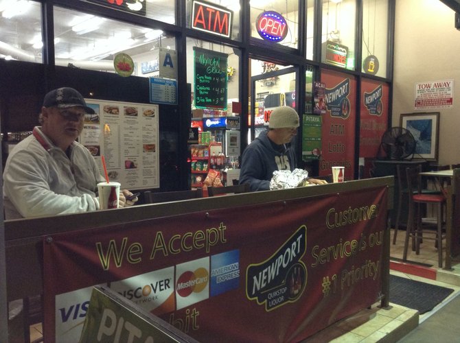 Customers Anthony and Dan at outside counter