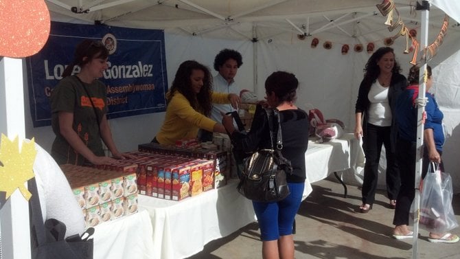 Gonzalez (right) and staff hand out turkeys in Sherman Heights