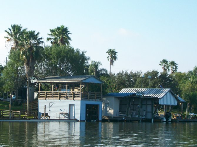 Boat houses line the Arroyo River in Arroyo City, Texas.
