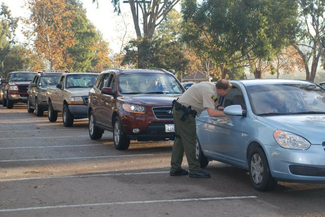 Cars line up outside Mira Costa College to surrender unwanted firearms. Photo: San Diego Sheriff