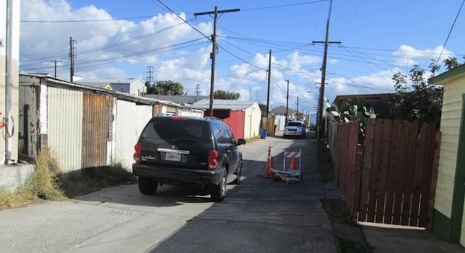 Unmarked vehicles blocked alley from both ends.