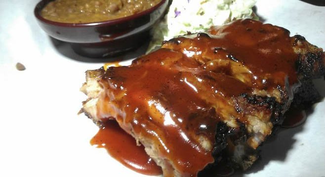 Phil's baby back ribs, charred from the grill and smothered in the stickiest barbecue sauce of all time.