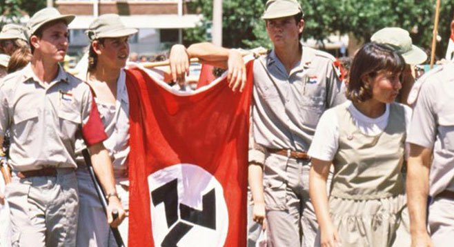 Youths carrying the Afrikaner Weerstandsbeweging (African Resistance Movement) flag during a right-wing rally in Klerksdorp in October 1993. Courtesy of The South African History Archive (SAHA).