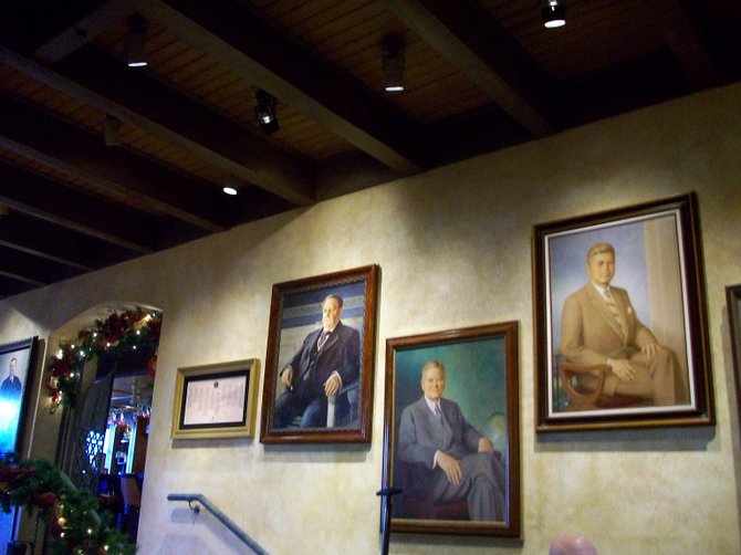 Classy Presidential Lounge paintings line the deep wood walls at the Mission Inn Hotel in Riverside.