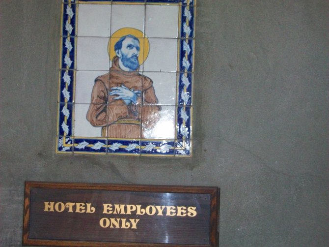 Pious sign on the wall at the Mission Inn Hotel in Riverside.