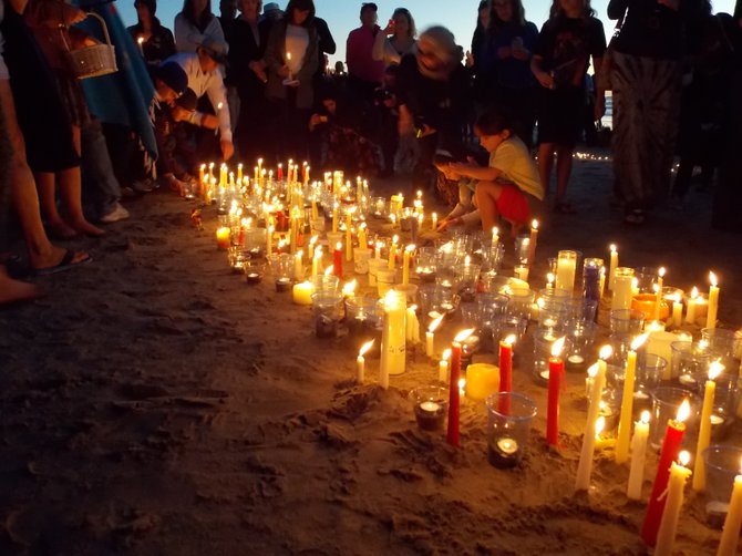 Those on shore with candles placed them in the sand.
