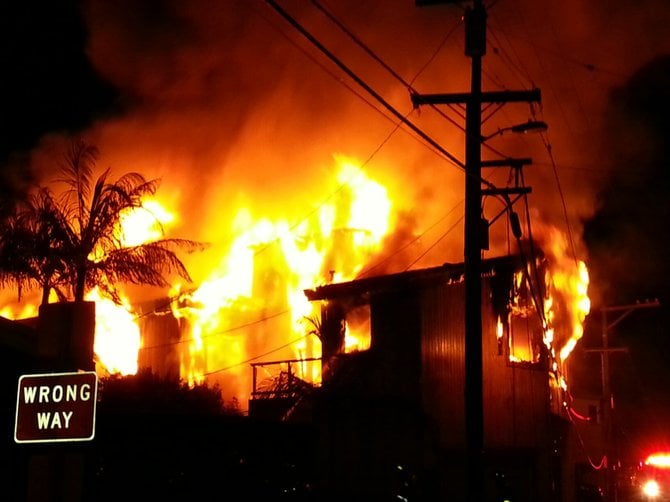 Flames rise high as the fire ripped through the wooden house