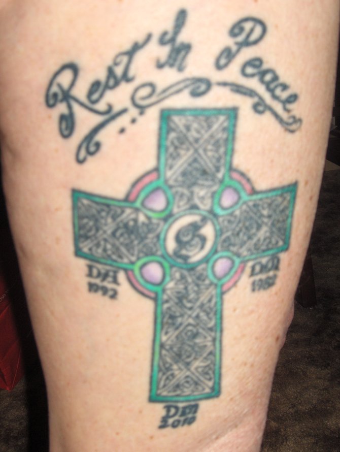I had this tattoo done in 2002 as a memorial to my brother who passed in 1982 and sister in 1992.  In 2010, I added the initials of my last remaining sibling.  It was done by Rob at Avalon in P.B. over a 3 hr. period, the coloring done later.  The intricacy is amazing.  The photo doesn't do it the justice Rob's talent deserves.
Denise, Lakeside  Age 52  Retired.