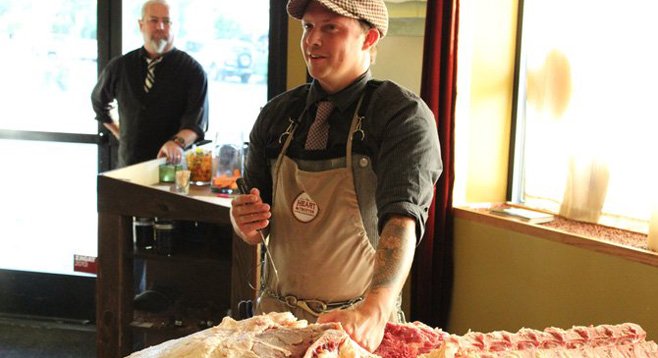 The Heart & Trotter butcher James Holtslag breaks down a beef hindquarter at Alchemy restaurant. - Image by Chad Deal