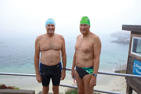 Drew Downs (left) and Richard Walker swim daily at dawn in La Jolla Cove. They were recently blocked by a large and aggressive sea lion who bared his teeth whenever they tried to enter the water.