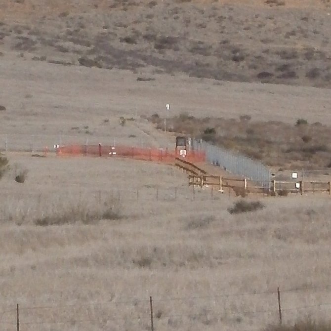Section of closed trail (surrounded by temporary orange fencing)