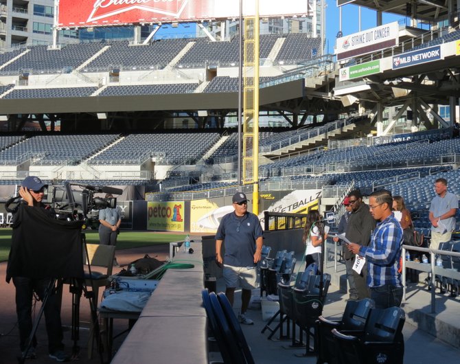 A candidate reading a script in front of cameras inside Petco Park for a chance to become the new P.A. announcer for the San Diego Padres.