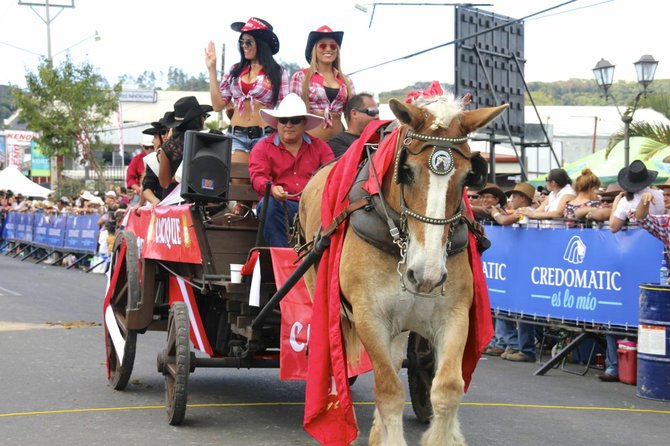A wagon full of cowgirls passes as a float at the annual "tope," or horse parade.