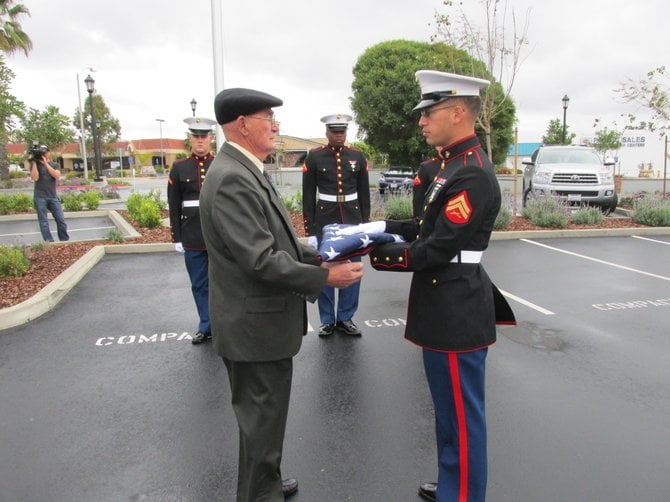 Retired Marine Vic Carusana presents his new flag to a Camp Pendleton honor guard