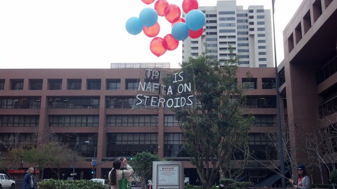 Protesters use helium-filled balloons to float their message in front of federal government buildings downtown