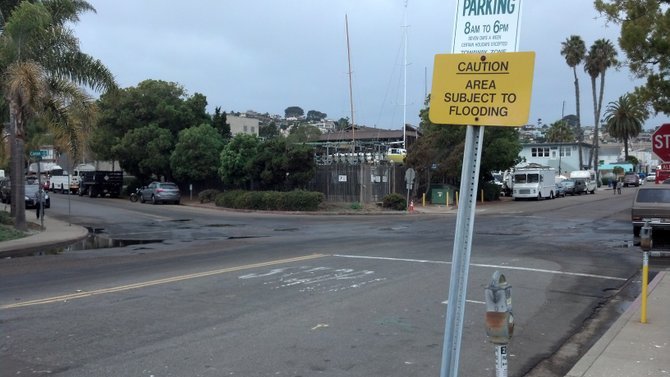 Puddles in road at Anchorage Lane and Cañon Street in Point Loma, after high tide