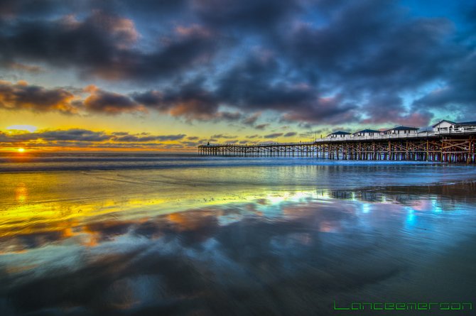 The clouds reflect off the water during a beautiful sunset at Crystal Pier.