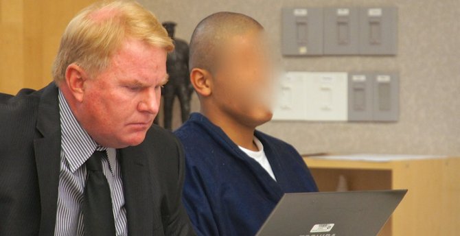 Defender Jeff Reichert w Ruben Cardenas -- judge ordered his face obscured. Photo by Eva.