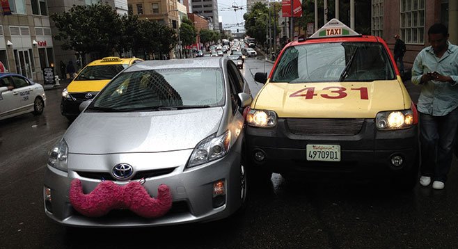 Lyft and Uber drivers report that taxi drivers have intentionally his their vehicles.