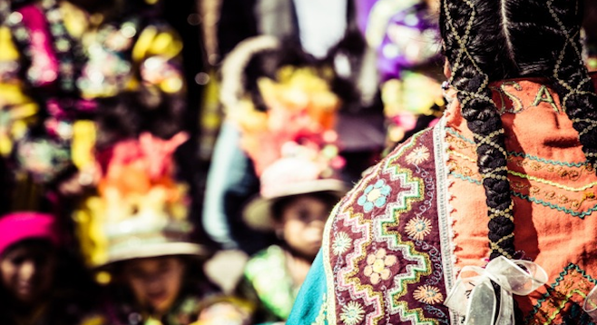 Peruvian woman in traditional dress at the market. (stock photo)