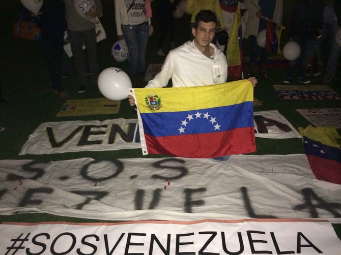 Venezuelan demonstrator holding a sign of protest