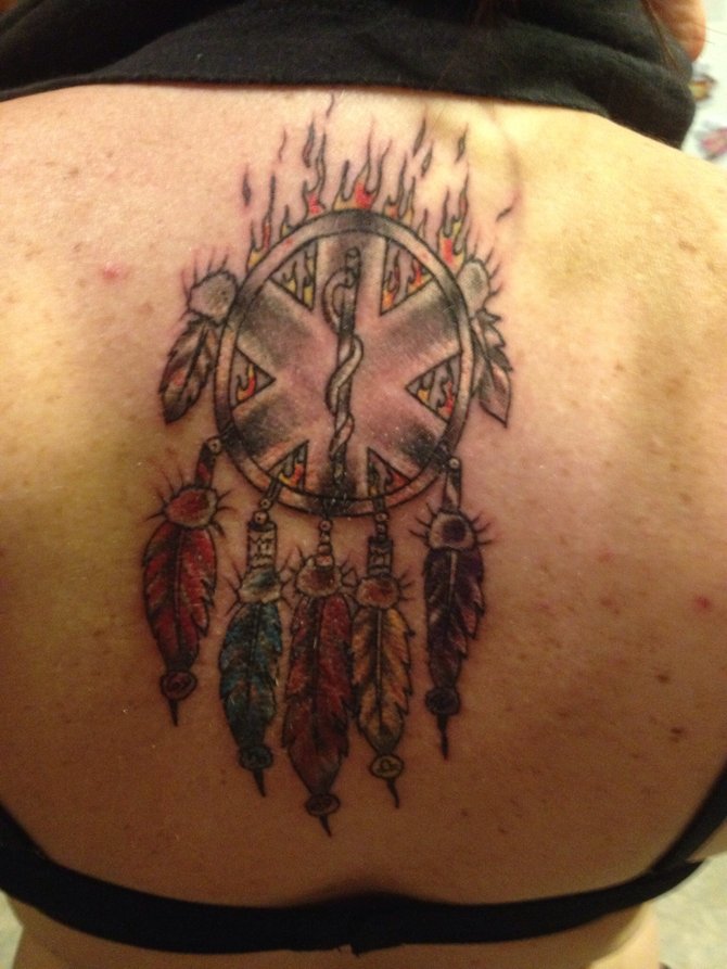 The feathers in the dream catcher represent each of my children. Each one is their favorite color and zodiac. I am a paramedic, which is represented by the star of life inside the dream catcher. The fire behind the dream catcher signifies my passion for my life but also that God is in control.