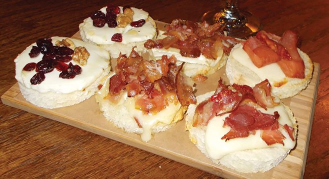 For $6, you six bruschettas — two with mozzarella, prosciutto, and grilled tomatoes; two with brie and slices of bacon; and the last two with goat cheese, cranberries, walnuts, and honey.