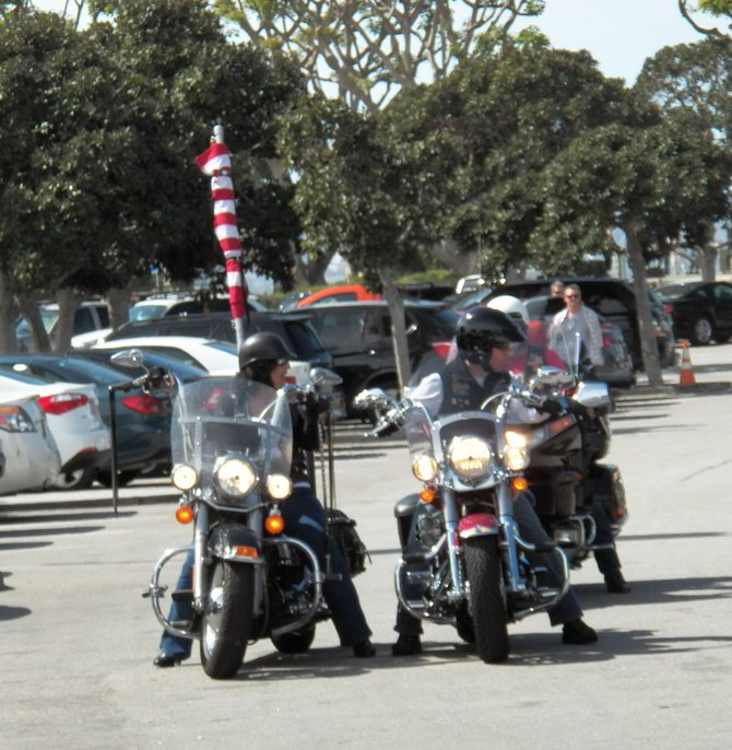 Veteran-affiliated motorcycle riders of the honor guard escort paying respects as they leave behind "The Wall That Heals."