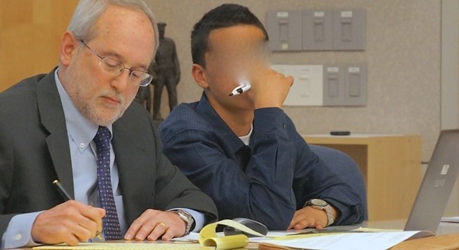 The judge ordered the face of defendant Salazar to be obscured (defense attorney Jeff Martin on left).
