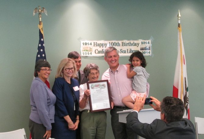 Encinitas and San Diego County officials present a proclamation to Irene Kratzer (center), celebrating 100 years of the Cardiff Library.