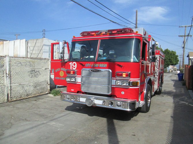 Firetruck responding to the trash can fire in the alley of the 2900 block of National Avenue.  They quickly doused the fire.