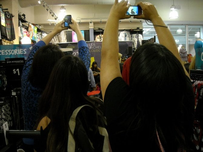 Fans hoist their cameras for a photo of Lea Michele