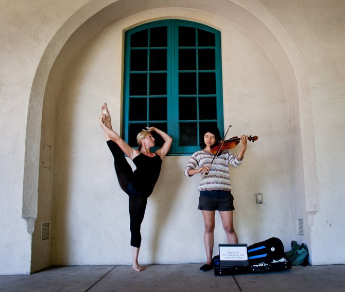 Ballerina Carmela Rosas at Balboa Park improvising with a violinist playing for change to pay her college tuition. 