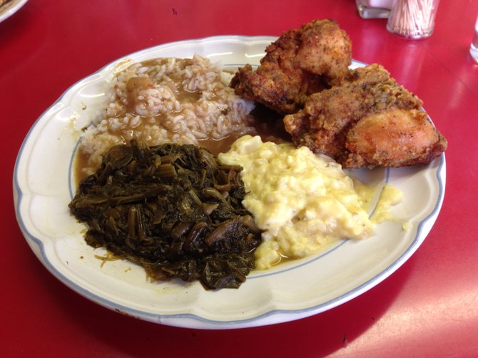 Heaping plate of fried chicken, collard greens, potato salad and gravy rice. I actually ate more than this. Sister Pee Wee's Soul Food.