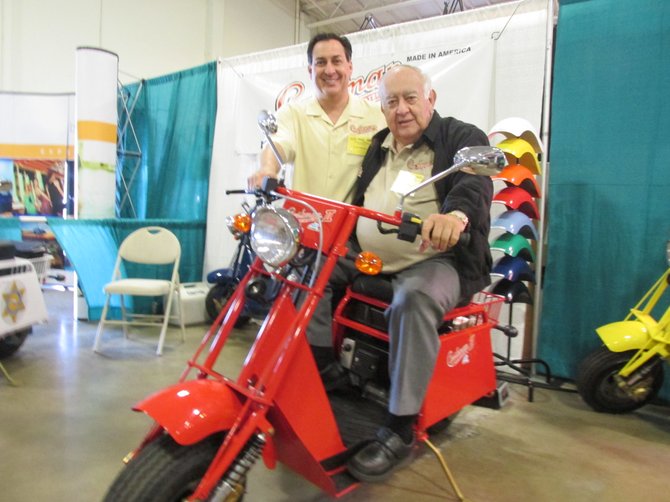 Steve and Jack Chalabian show off their replica of the classic 1965 Cushman motor scooter.