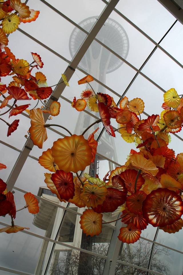 100 foot suspended glass sculpture in the Glasshouse of the Chihuly Glass and Garden Museum with the Seattle Space Needle in the background.

Seattle, Washington