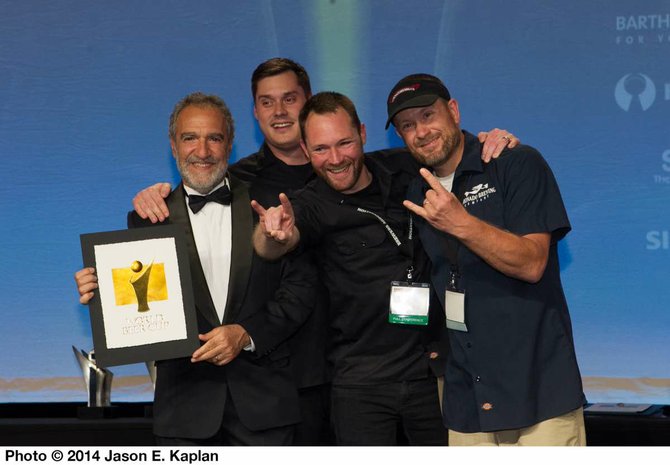 Coronado Brewing Company's staff accept a gold medal for Islander IPA from Brewers Association president Charlie Papazian at the 2014 World Beer Cup in Denver, Colorado. - Image by Jason E. Kaplan