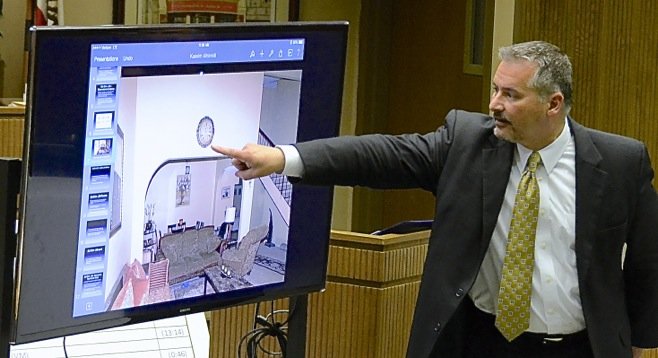 Richard Berkon pointed to an evidence photo showing a clock in the home. Photo Weatherston