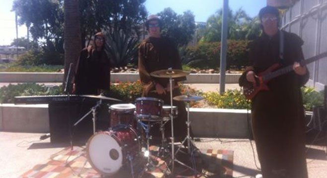 The friar-disguised Wheeler brothers busking outside the ballpark