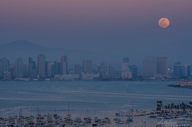Full Moon rising over the city at dusk prior to the "Blood Moon" Lunar Eclipse by Alex Baltov