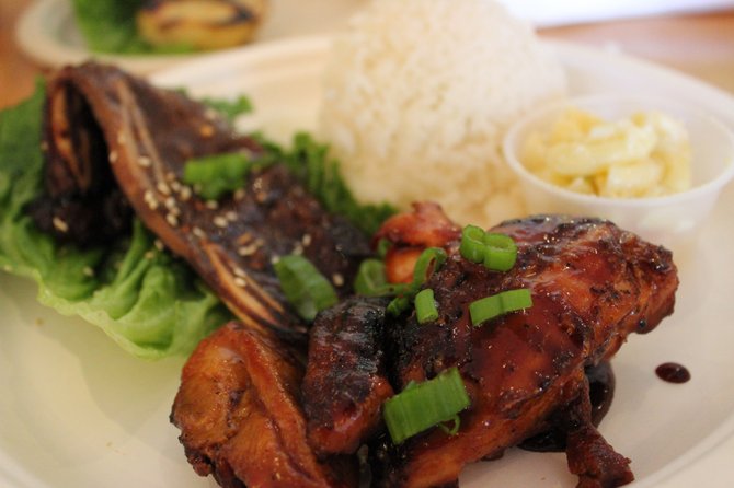The classic Huli Huli Chicken is tender, coated in house teriyaki, and topped with chives.