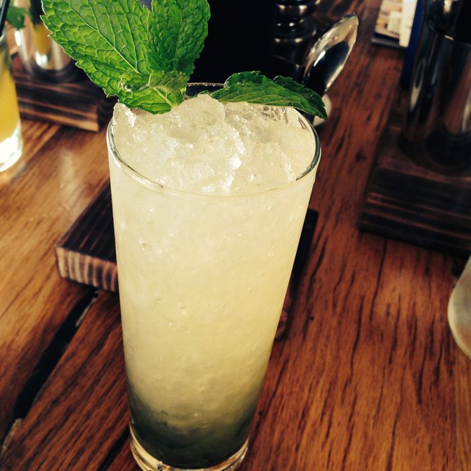 Hola Y'all mescal cocktail with ￼￼￼￼￼￼￼￼￼￼bbq-rub infused vodka, fresh cilantro, and lime