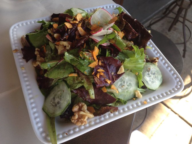 100 Wines Mixed Green salad has toasted almonds, radish, cucumbers, blackberries and a basil vinaigrette.