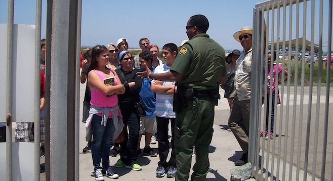 Border Patrol agent Kris Stricklin explaining to people that they cannot come in until someone else leaves