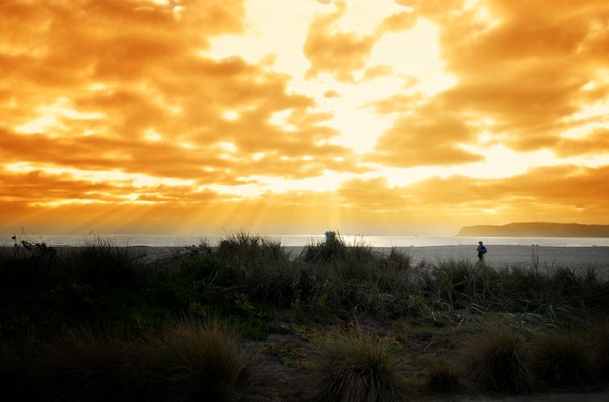 A jogger enjoys the San Diego sunset off of the beach of Coronado.