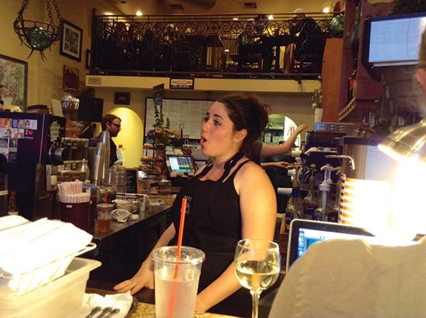 Julie sings an aria from behind the counter