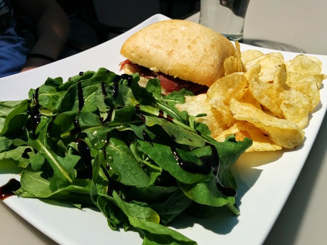 Sandwich with arugula salad on the side
